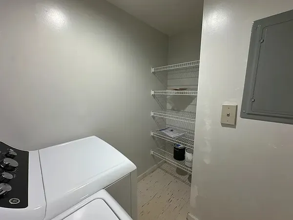 a view of storage and utility room with washer and dryer