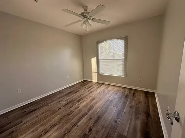 wooden floor in an empty room with a window