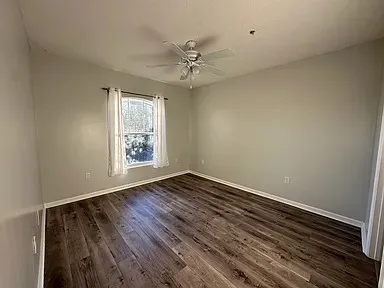 wooden floor in an empty room with a window