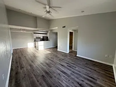 a view of empty room with wooden floor