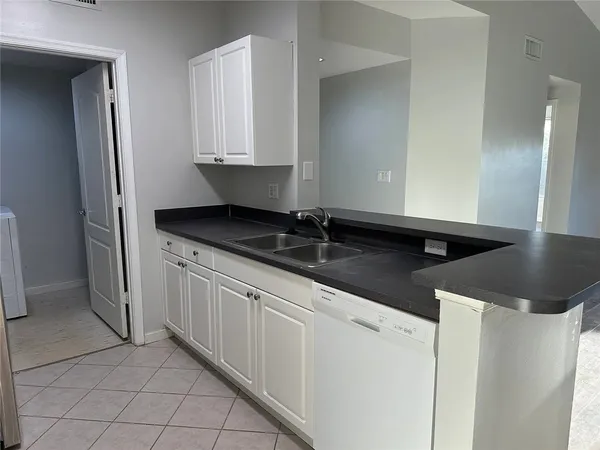 a kitchen with granite countertop a sink and a stove