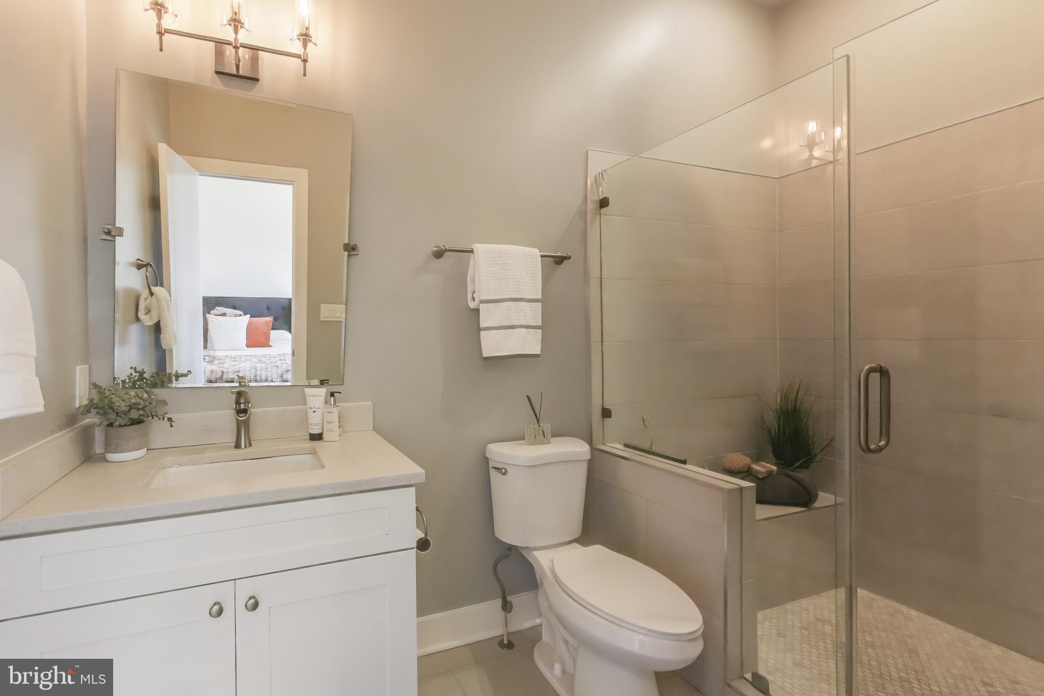 2012 D Street Northeast, Unit 4 Washington, DC 20002 - Photo 17 of 25 a bathroom with a toilet sink vanity and mirror