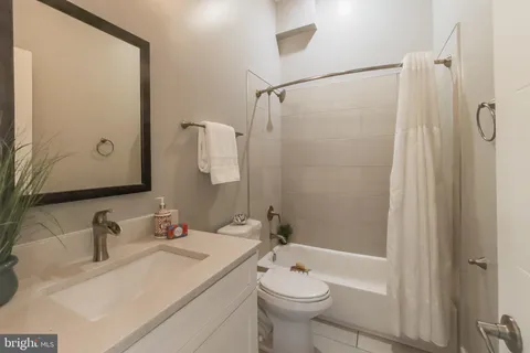 a bathroom with a sink toilet a shower and a mirror