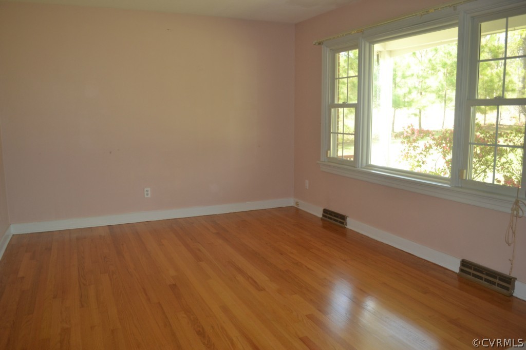 19701 Genito Road Moseley, VA 23120 - Photo 14 of 23 an empty room with wooden floor and windows