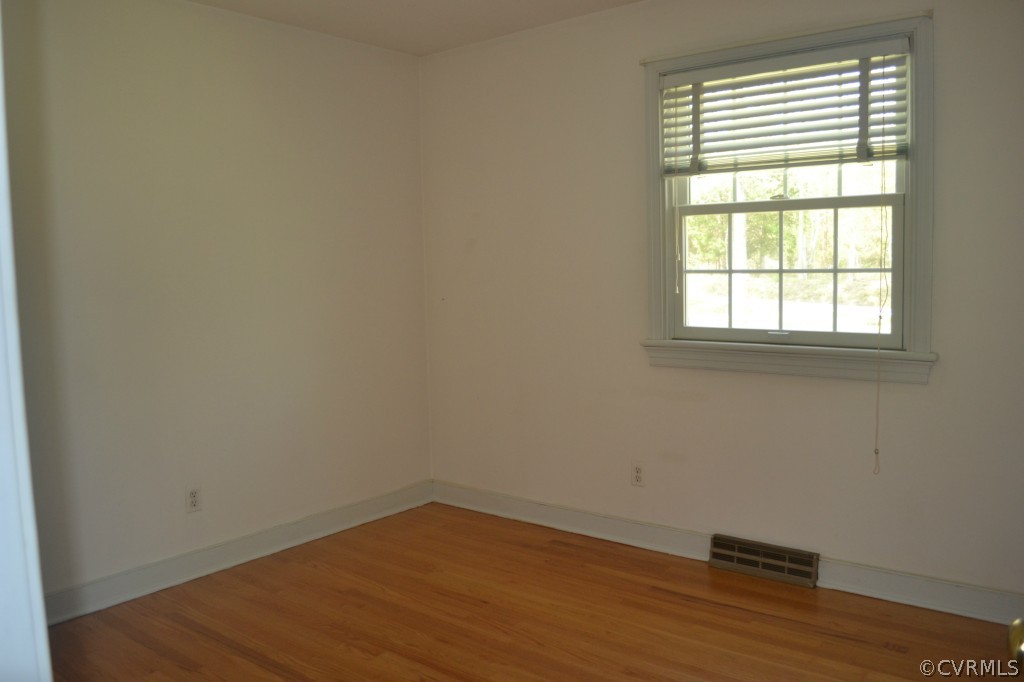 19701 Genito Road Moseley, VA 23120 - Photo 17 of 23 an empty room with wooden floor and a window