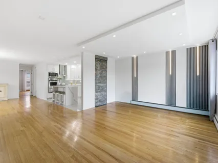 a view of a kitchen with wooden floor and a kitchen