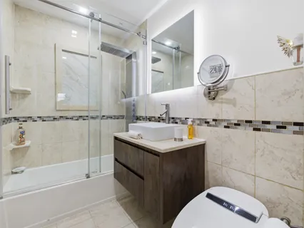 a bathroom with a sink a toilet and shower