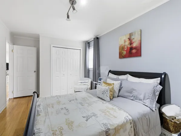 a bedroom with a bed and a painting on the wall