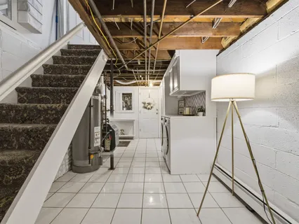 a view of a kitchen with a sink and cabinets