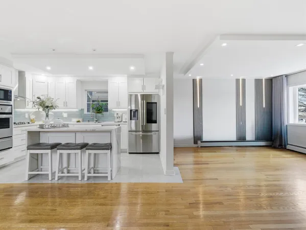 a kitchen with stainless steel appliances granite countertop a refrigerator and a stove top oven