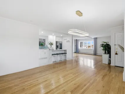 a view of a room with wooden floor and a window