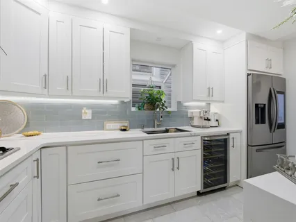 a kitchen with appliances a sink and cabinets