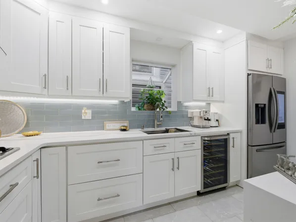 a kitchen with appliances a sink and cabinets