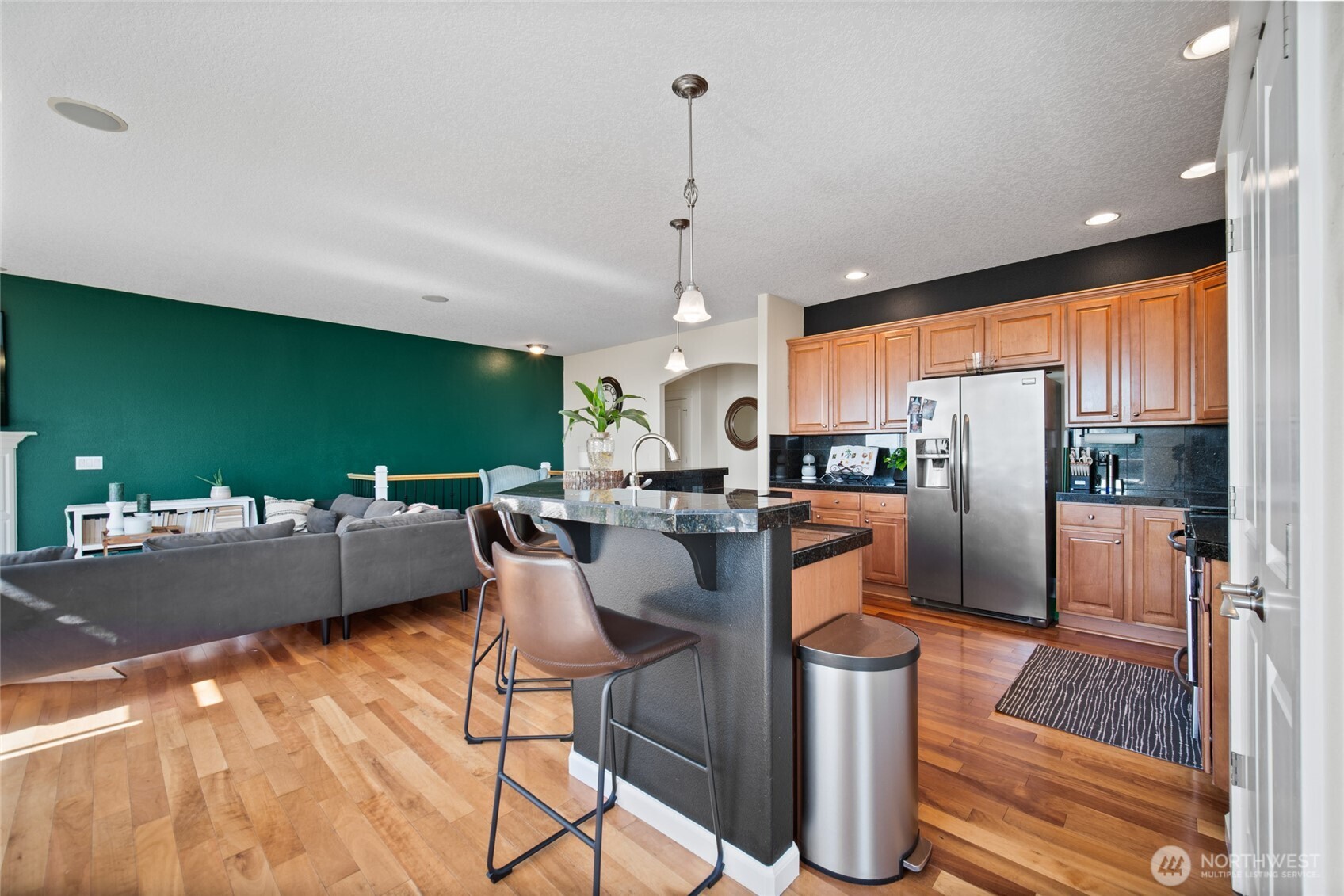 172 Blackjack Drive Kalama, WA 98625 - Photo 11 of 40 a kitchen with a table chairs refrigerator and cabinets