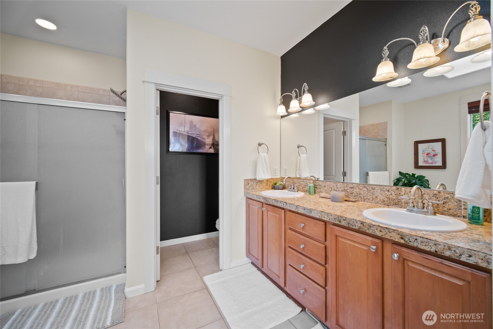 172 Blackjack Drive Kalama, WA 98625 - Photo 25 of 40 a bathroom with a granite countertop sink a mirror and a shower