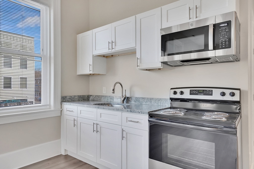 a stove top oven sitting inside of a kitchen