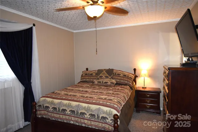 a bedroom with a bed and a mirror on dresser