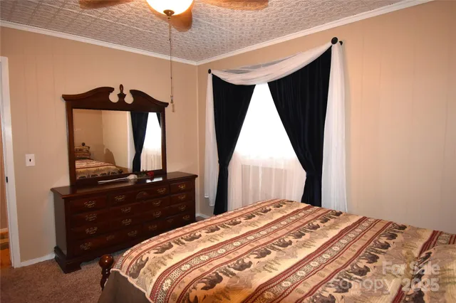 a bedroom with a bed and a flat tv screen