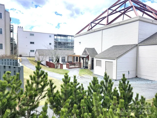 a view of a house with a wooden fence