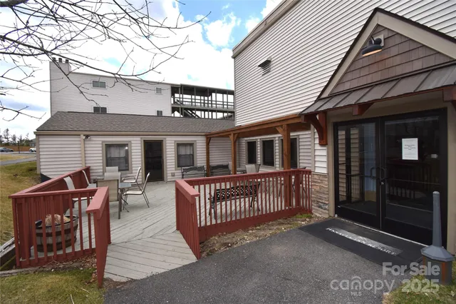a view of a wooden deck with a yard