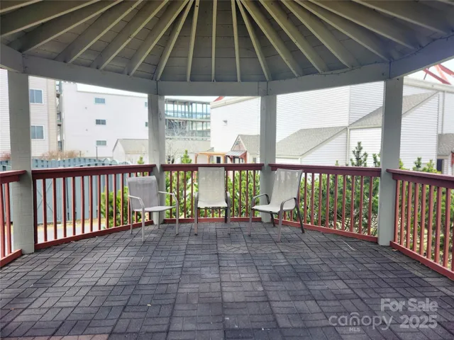 a view of a dining room with furniture a kitchen and chandelier