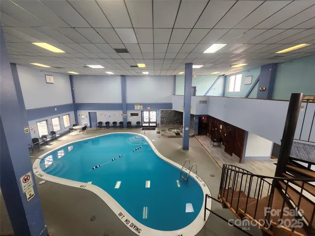 a kitchen with stainless steel appliances granite countertop a sink a stove top oven a counter space and cabinets