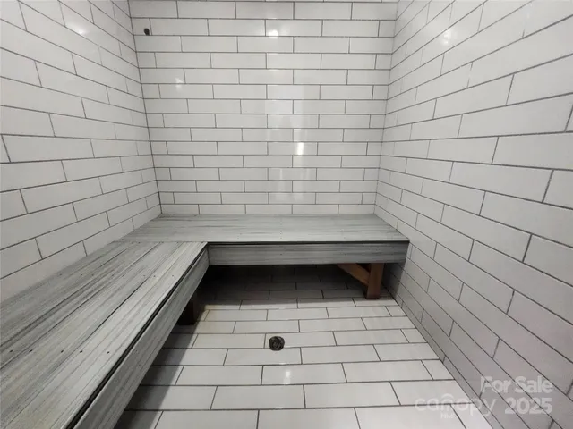 a room with pool table and wooden floor