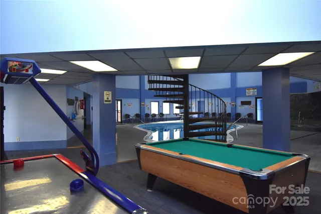 a view of hallway with stairs and wooden floor