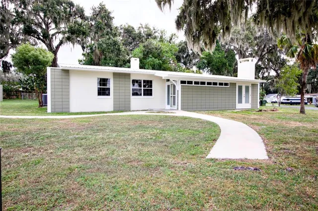 a backyard of a house with yard and outdoor seating