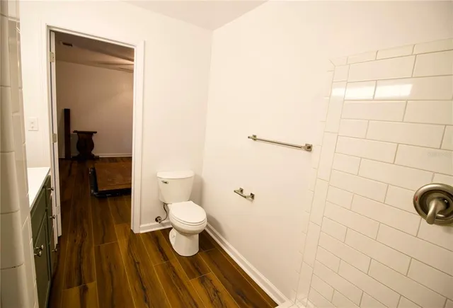 a bathroom with a sink shower and a mirror