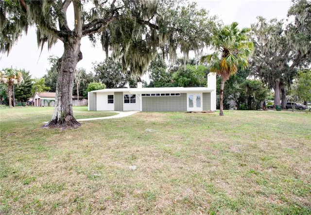 a view of a porch with furniture and garden