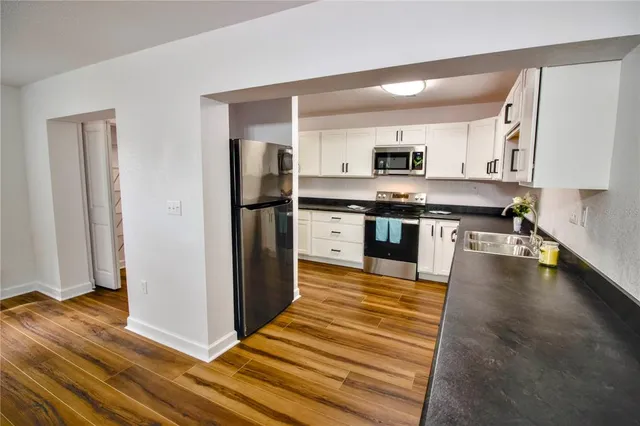 a kitchen with stainless steel appliances granite countertop a stove and a refrigerator