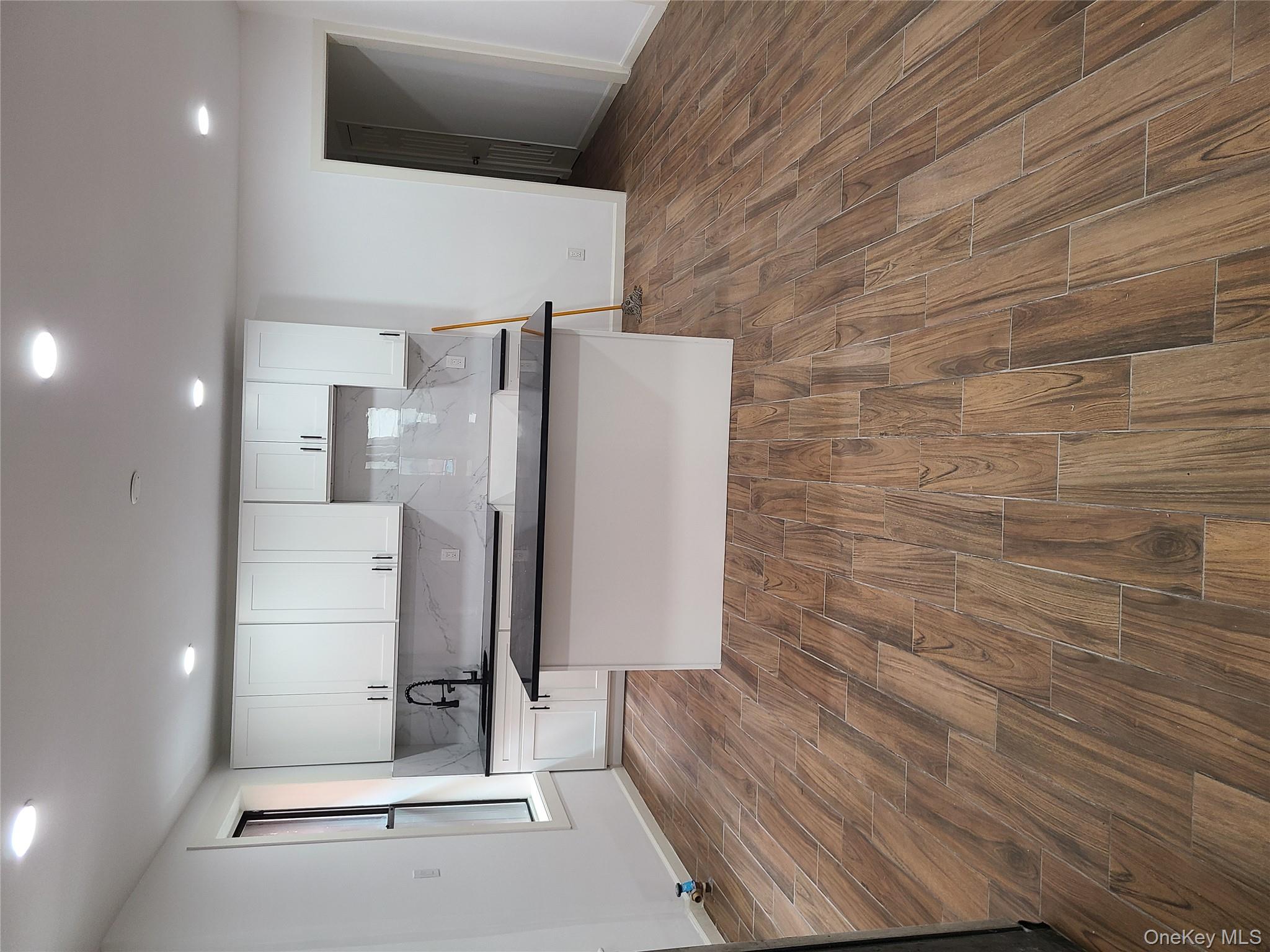 1309 Seneca Avenue Bronx, NY 10474 - Photo 4 of 20 a large kitchen with stainless steel appliances granite countertop a large counter top a sink and a refrigerator