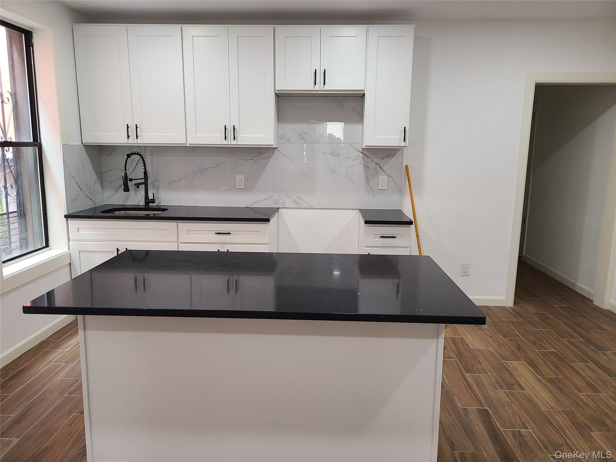 1309 Seneca Avenue Bronx, NY 10474 - Photo 5 of 20 a kitchen with a stove and white cabinets
