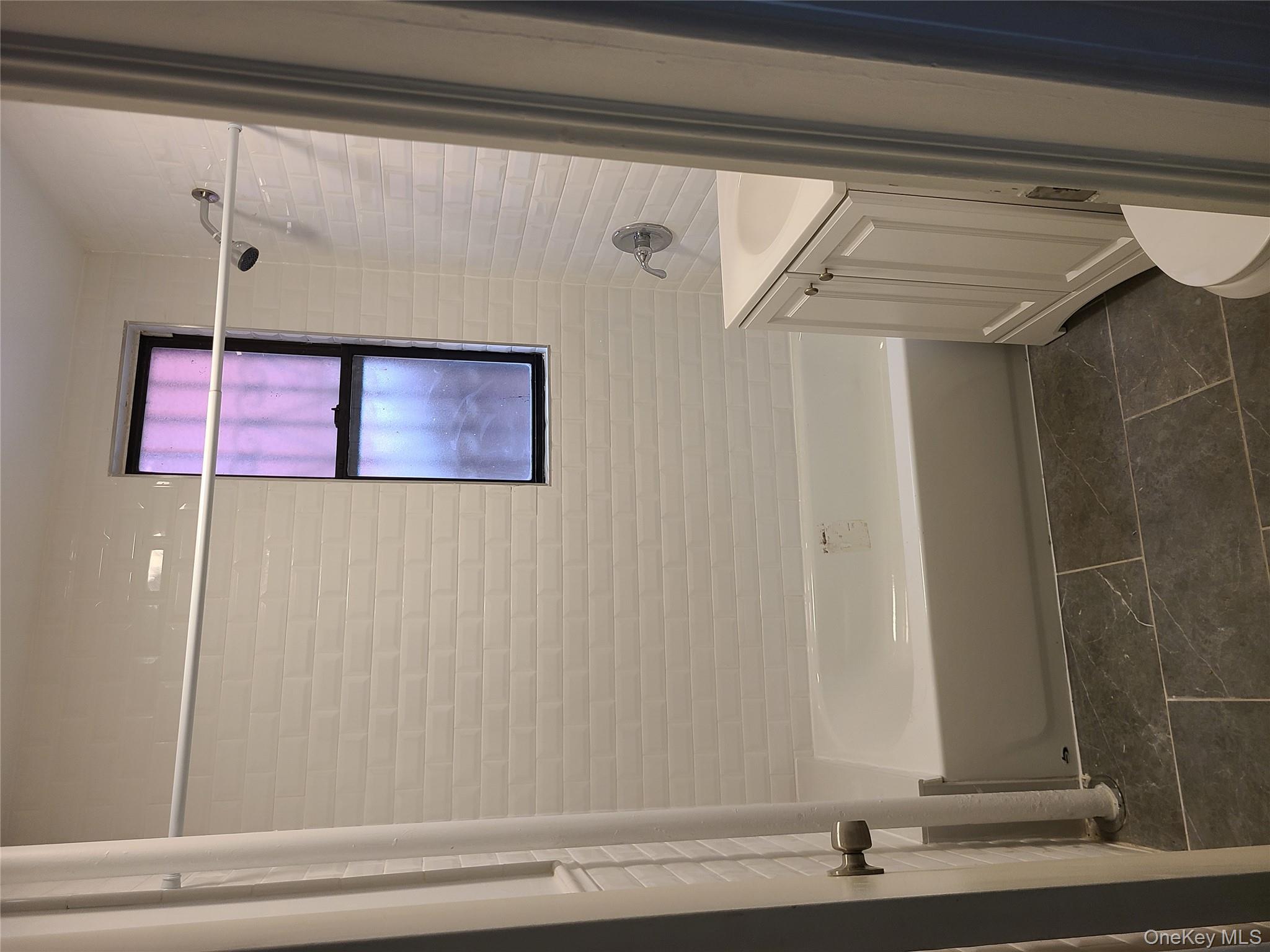 1309 Seneca Avenue Bronx, NY 10474 - Photo 7 of 20 a bathroom with a shower and a bath tub