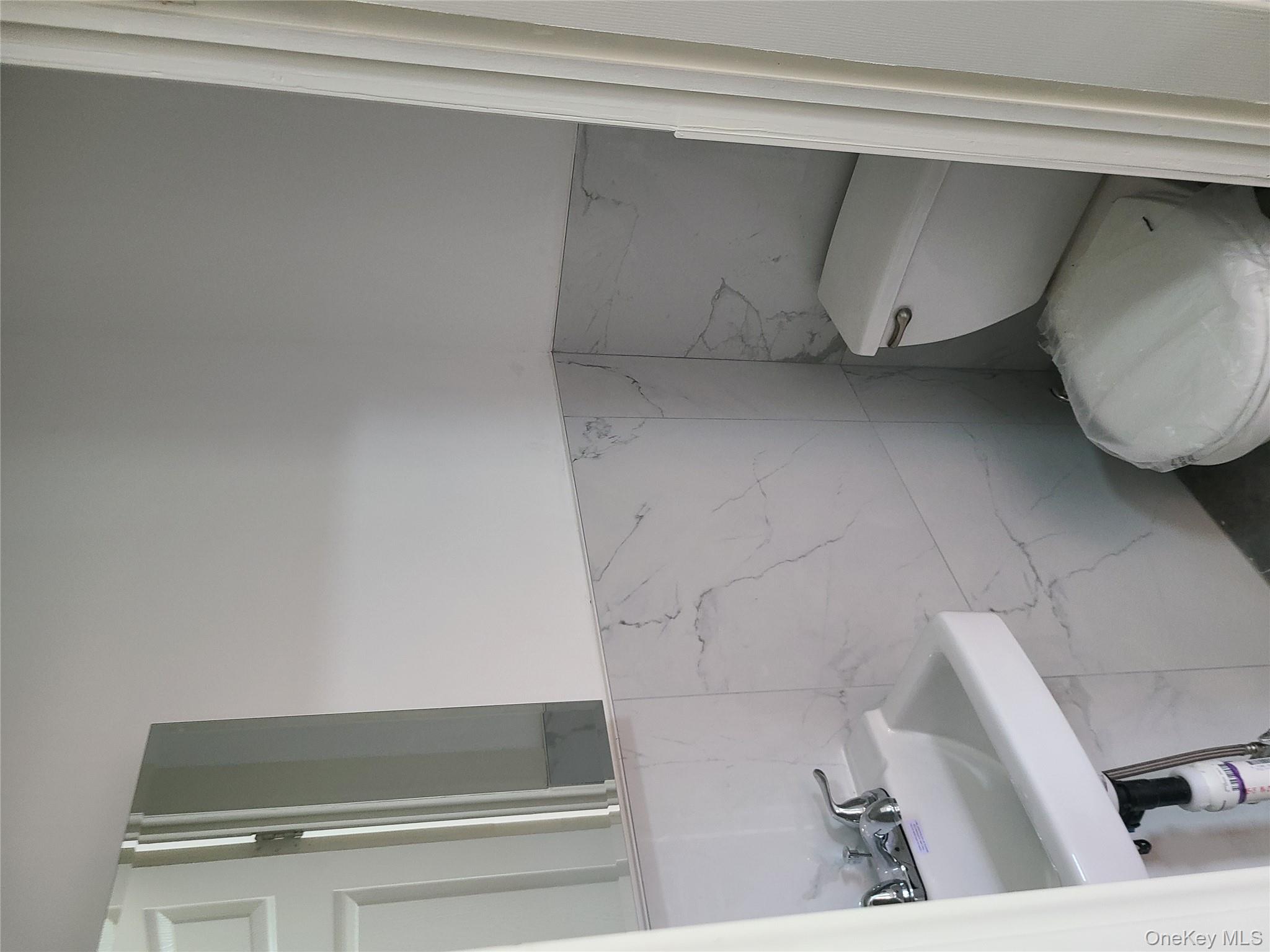 1309 Seneca Avenue Bronx, NY 10474 - Photo 10 of 20 a bathroom with a toilet sink and mirror