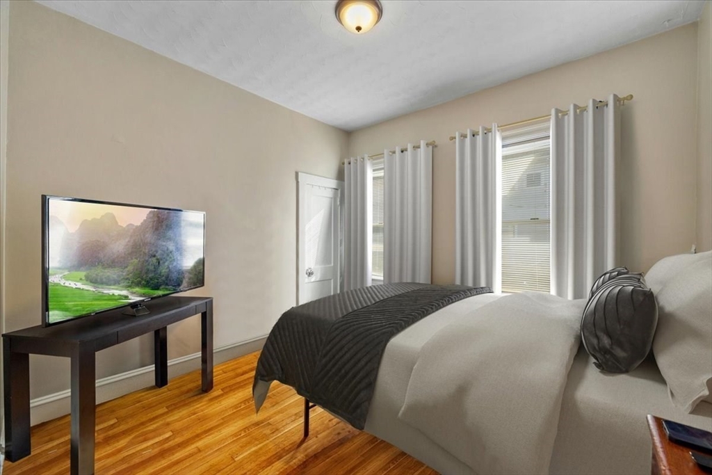 225 Mulberry Street Fall River, MA 02721 - Photo 4 of 13 a bedroom with a bed and a flat screen tv