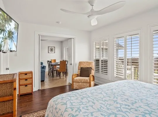 a bedroom with a bed and a large window