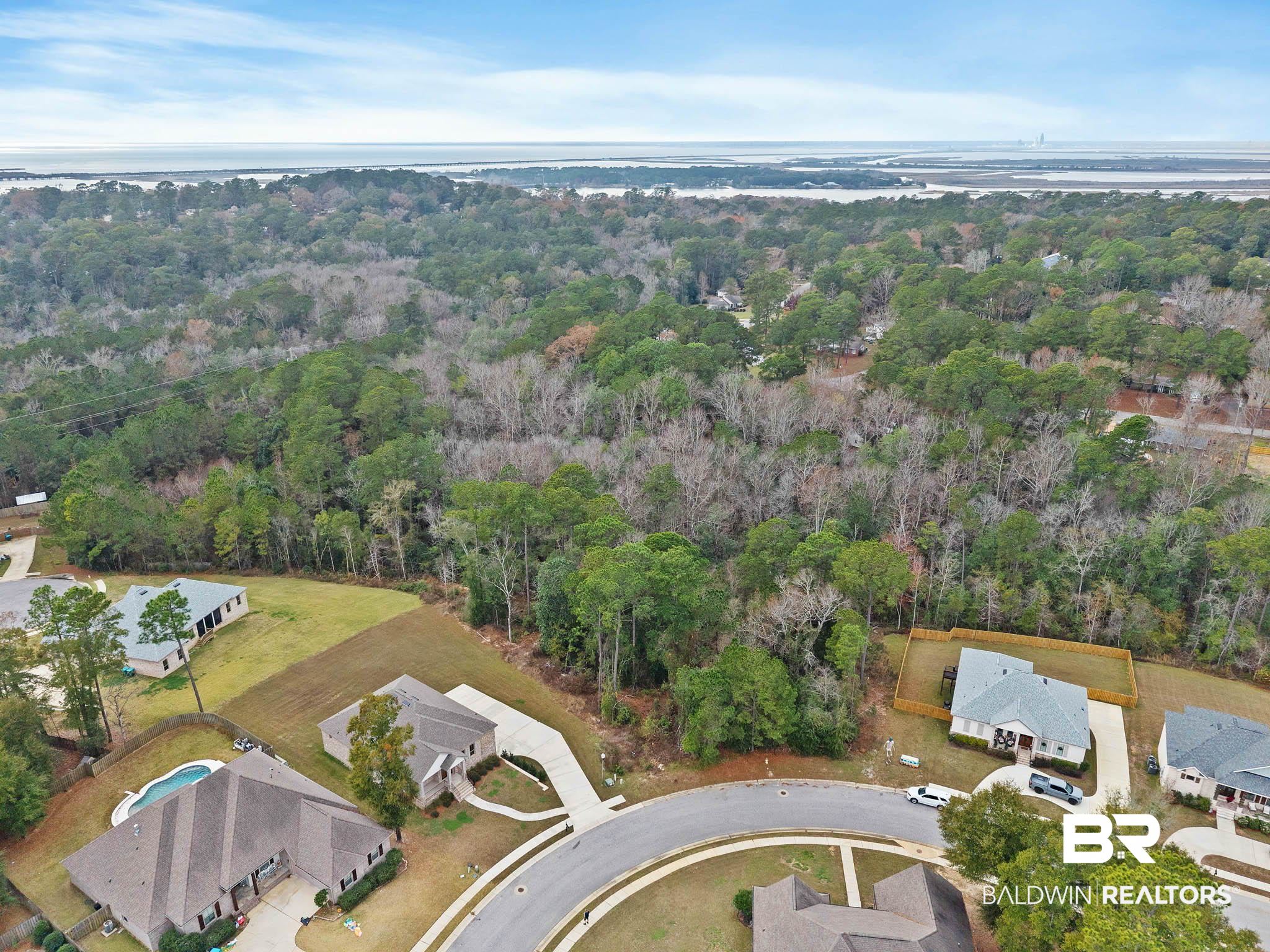6656 Garrison Drive Daphne, AL 36527 - Photo 5 of 57 Aerial view of property and surrounding area featuring a large body of water and nearby suburban area