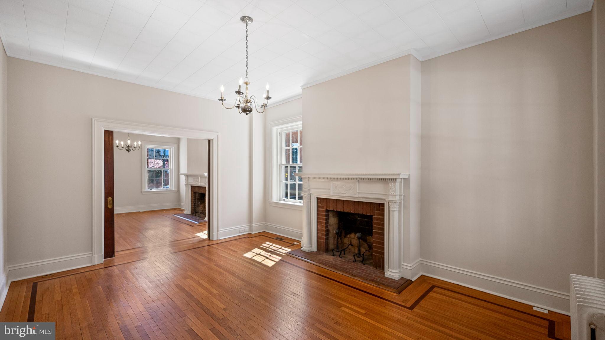110 North Court Street Frederick, MD 21701 - Photo 12 of 28 a view of a livingroom with wooden floor and a fireplace