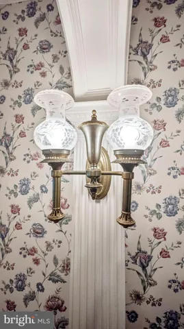 a view of a livingroom with wooden floor and a fireplace