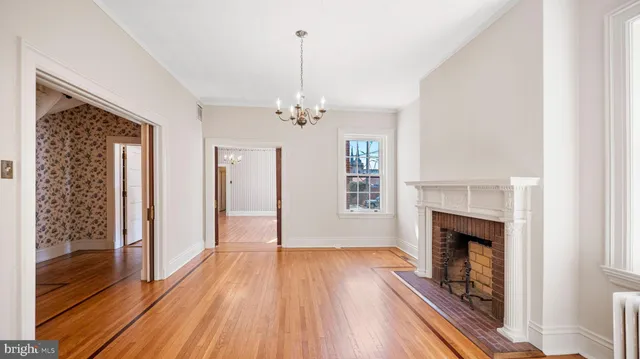 a view of a livingroom with wooden floor and a fireplace