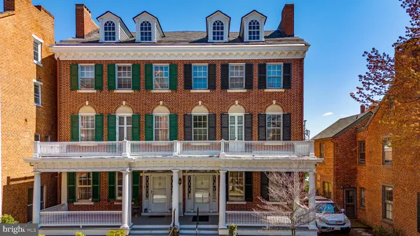 a view of a brick house with many windows