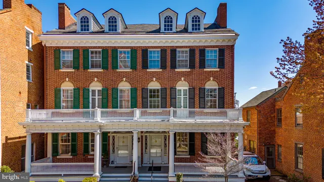 a view of a brick house with many windows