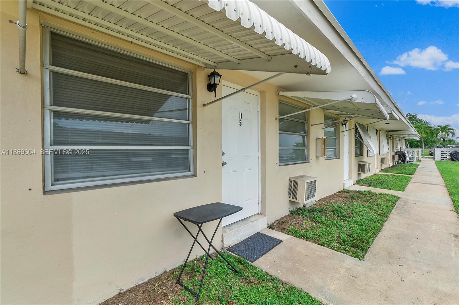 2901 Polk Street, Unit 14 Hollywood, FL 33020 - Photo 15 of 16 a front view of a house with a yard