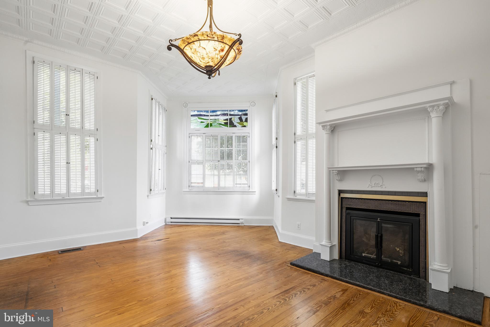 400 7th Street Southeast Washington, DC 20003 - Photo 8 of 23 a view of an empty room with a window and fireplace