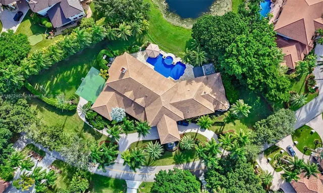 an aerial view of a house with a yard and garden