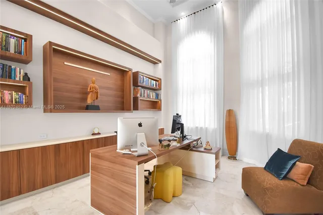 a room with pool table and windows