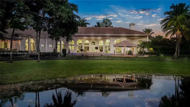 a front view of a house with swimming pool garden and outdoor seating
