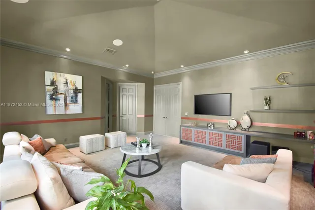 a living room with furniture and a book shelf